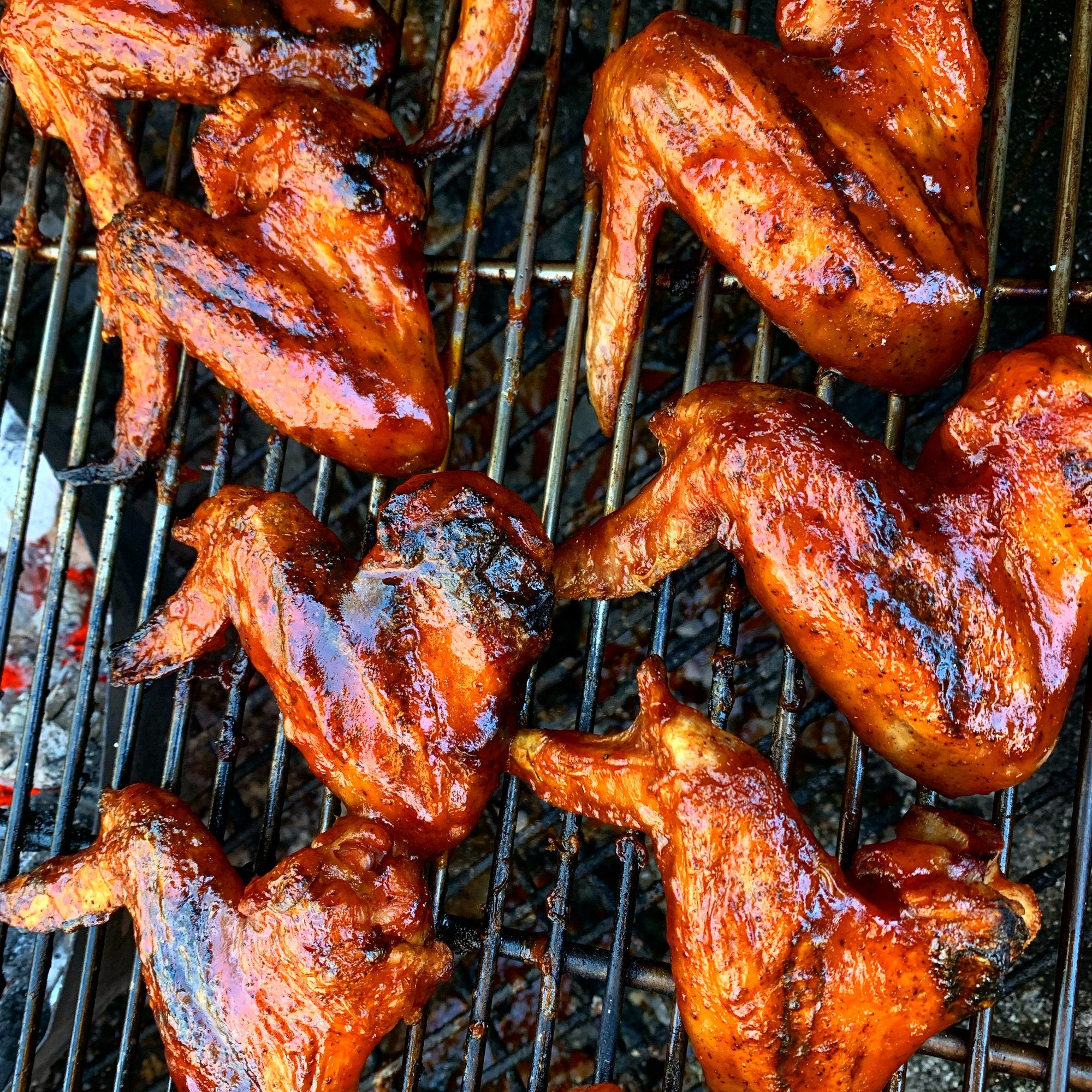 Cox Sauce wings on a charcoal grill