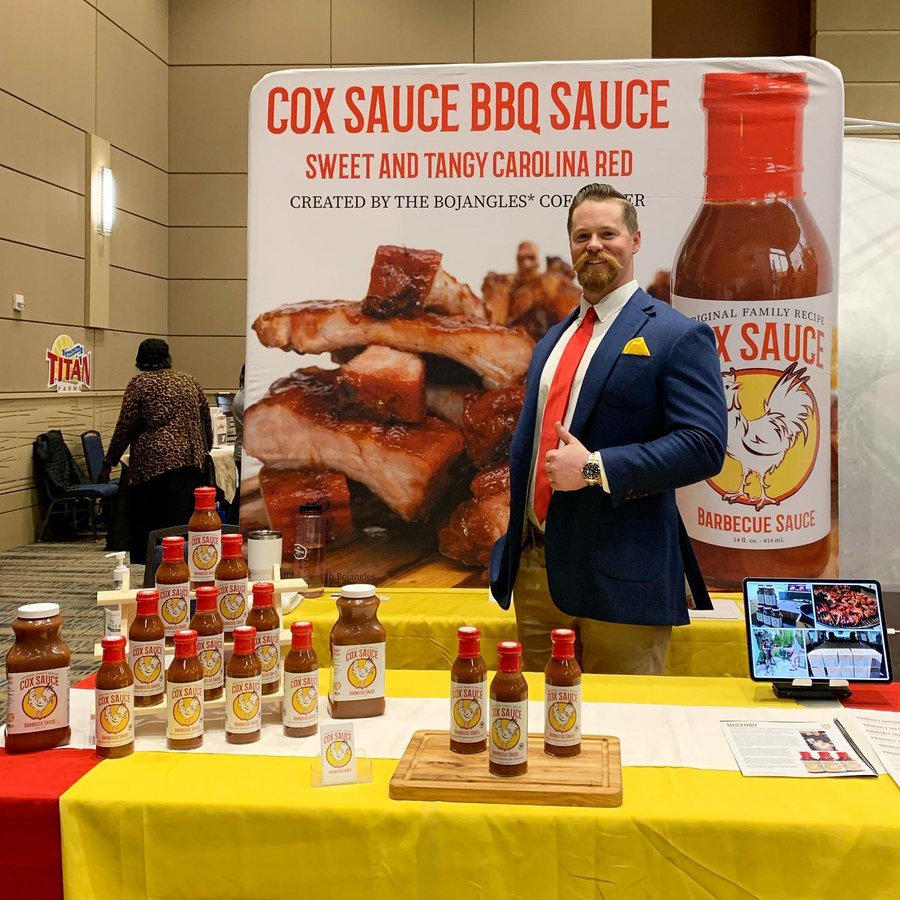 Cameron Cox with Cox Sauce at a trade show